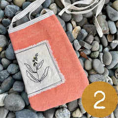 plant-dyed pocket purse with embroidered botanical patch