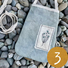 plant-dyed pocket purse with embroidered botanical patch