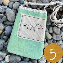 plant-dyed pocket purse with embroidered botanical patch