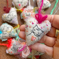 heavily stitched cat hearts in honor of jeff