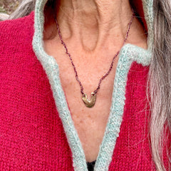 arch necklace in a plant-dyed matchbox