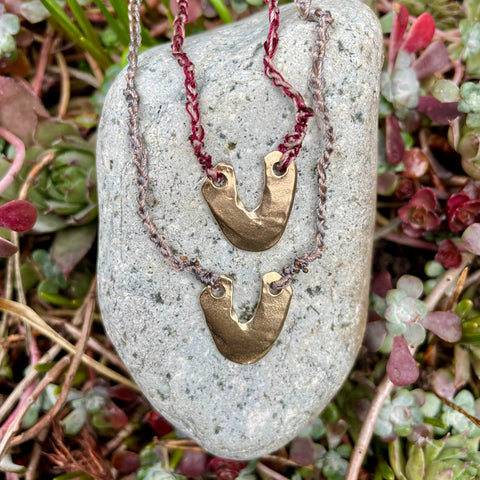 arch necklace in a plant-dyed matchbox