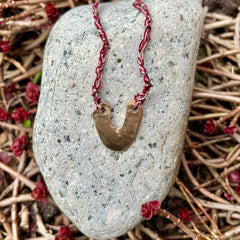 arch necklace in a plant-dyed matchbox