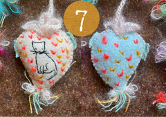 heavily stitched cat hearts in honor of jeff