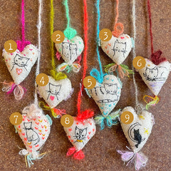 heavily stitched cat hearts in honor of jeff