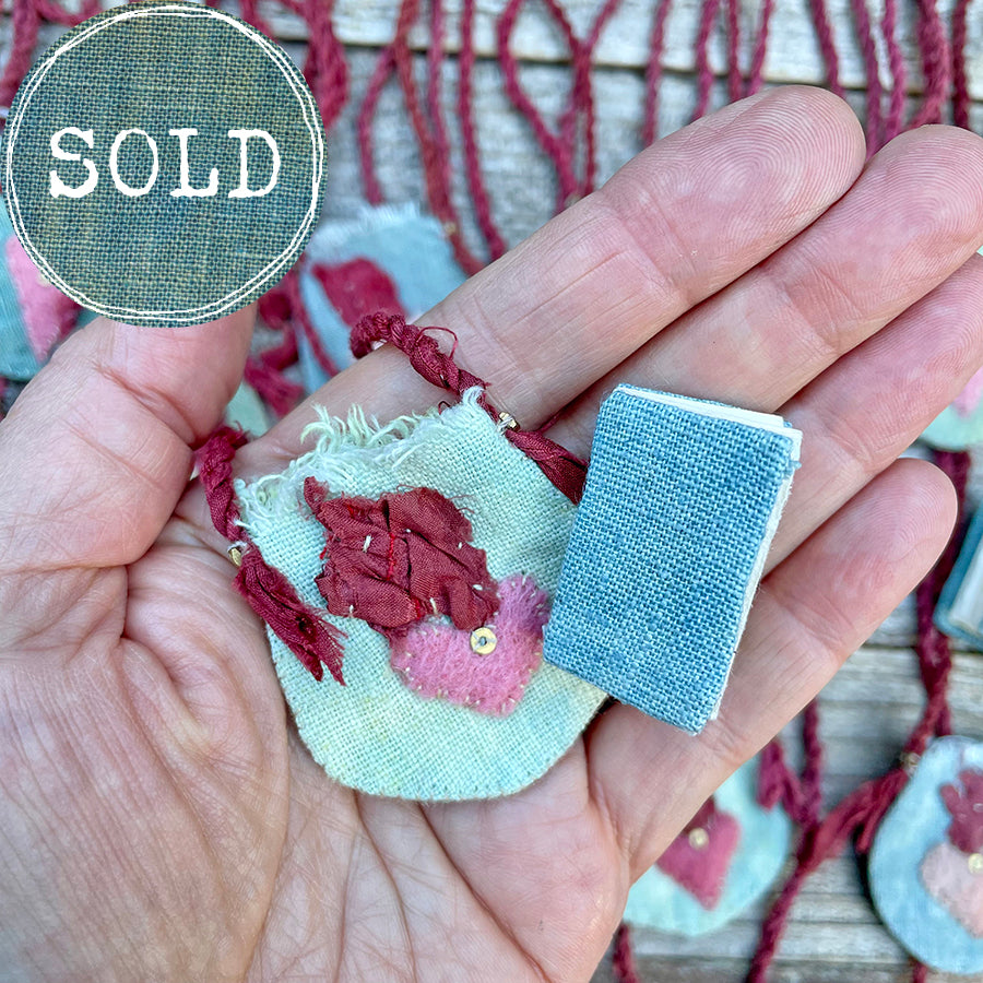 indigo heart amulet pouch with a teeny tiny book