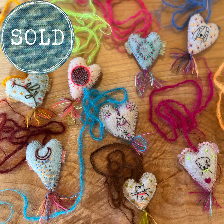 heavily stitched wool felt hearts