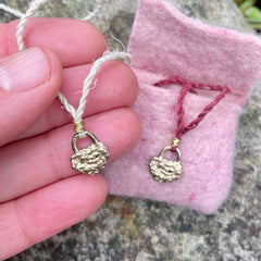 lock necklace on silk cordage in a little plant-dyed felt pocket