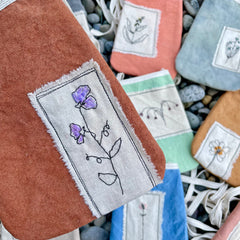 plant-dyed pocket purse with embroidered botanical patch