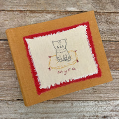 photo album: cat on a rug (ochre)