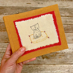 photo album: cat on a rug (ochre)