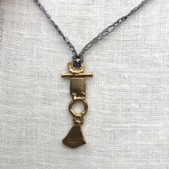 adjustable necklace: yellow bronze charm on slate grey crocheted cord