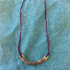 adjustable necklace: yellow bronze charm with crocheted deep wine cord