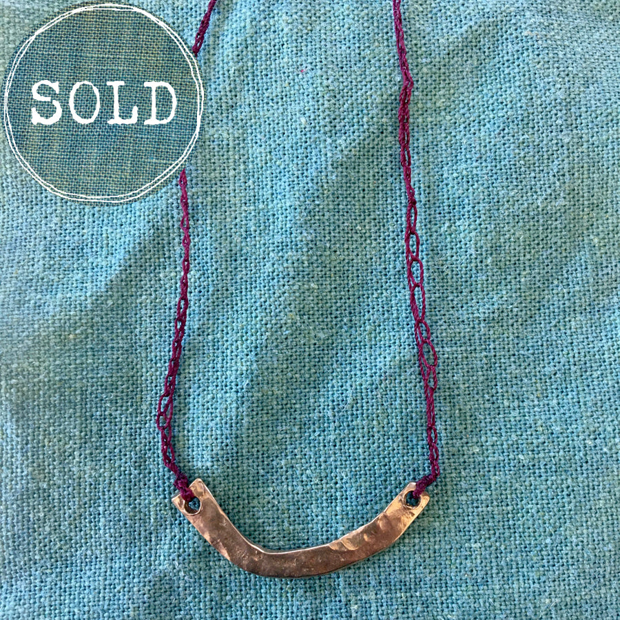 adjustable necklace: yellow bronze charm with crocheted deep wine cord