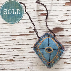 hand-stitched fabric amulet charm with adjustable clasp: blue
