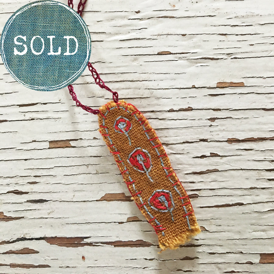 hand-stitched fabric amulet charm with adjustable clasp: ochre