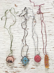hand-stitched fabric amulet charm with adjustable clasp: ochre