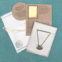 adjustable necklaces: yellow bronze charm with a trio of vintage beads on crocheted cord