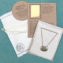 adjustable necklaces: yellow bronze charm with a trio of vintage beads on crocheted cord