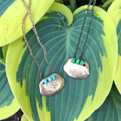 adjustable necklaces: yellow bronze charm with a trio of vintage beads on crocheted cord