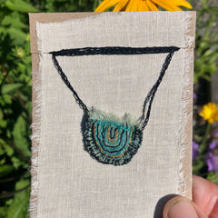 hand-stitched indigo amulet charm with adjustable clasp: smile