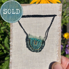 hand-stitched indigo amulet charm with adjustable clasp: smile