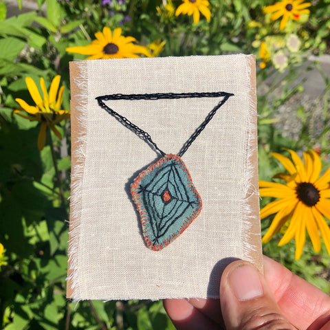 hand-stitched indigo amulet charm with adjustable clasp: web